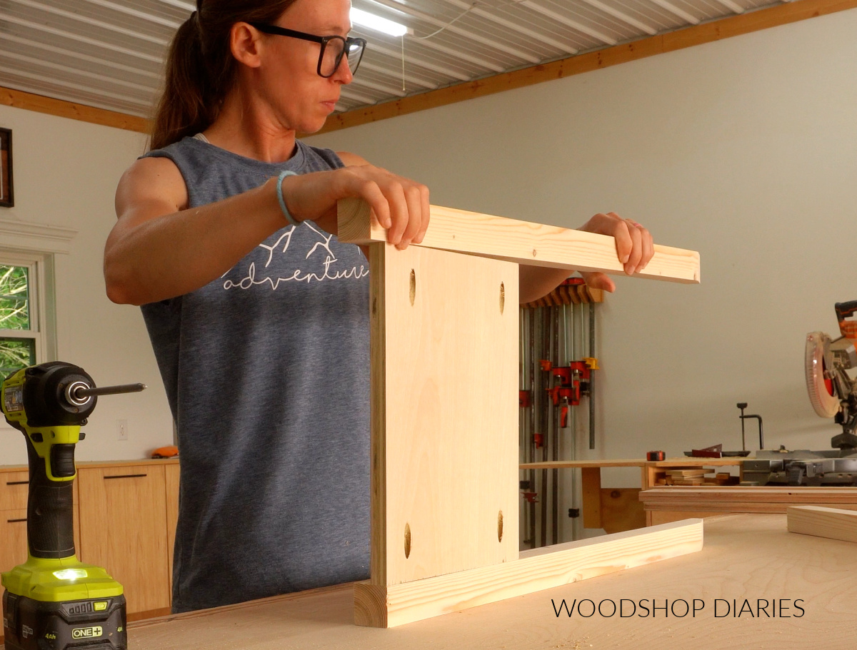 Shara Woodshop Diaries assembling side panels of console table on workbench