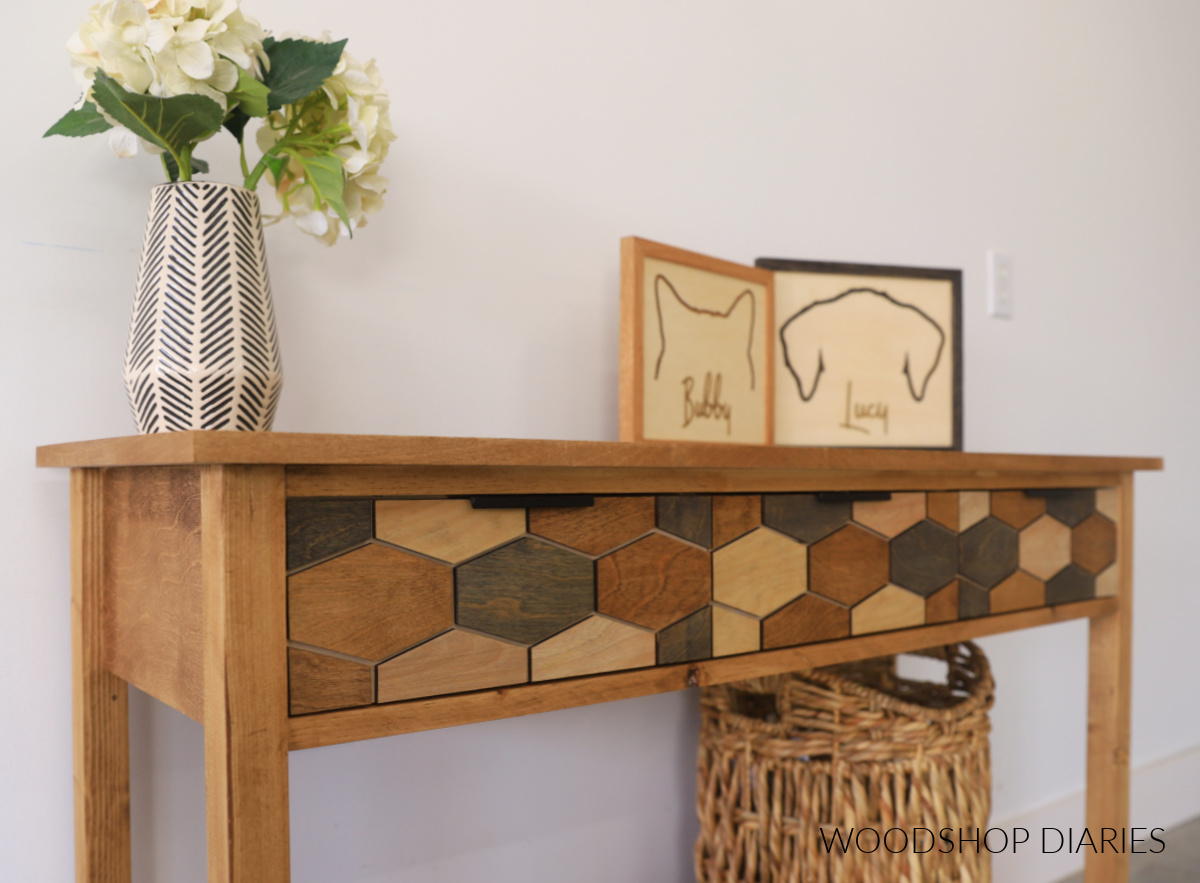Close up of drawer front overlay design on console table with drawers