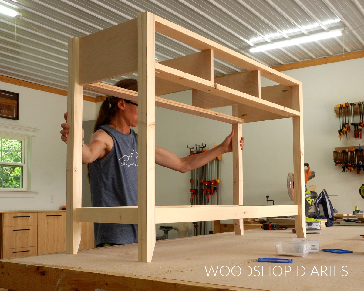 Console table frame assembled on workbench with shelf supports added around the bottom