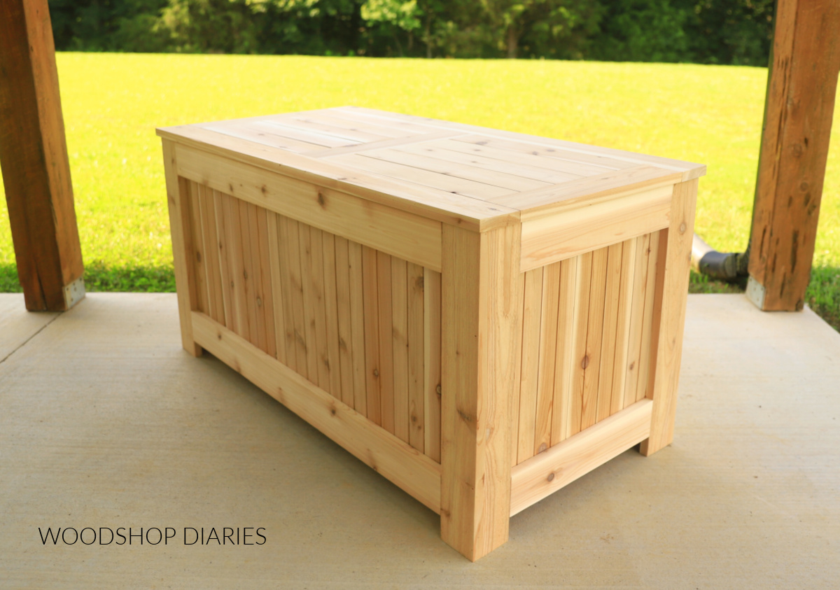 Completed DIY outdoor storage box with lid closed on porch