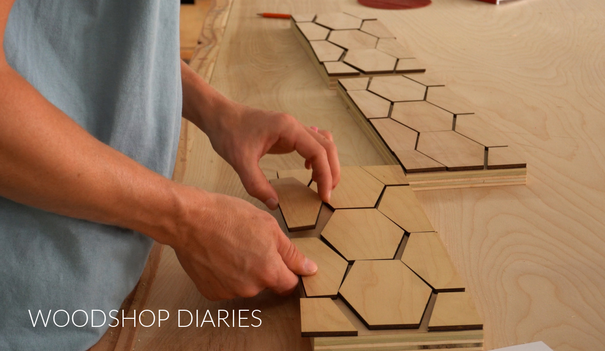 Hexagon ¼" plywood pieces cut and arranged on drawer fronts after being cut on laser
