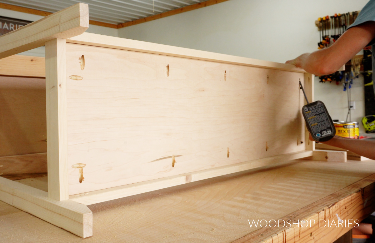 Shara Woodshop Diaries installing shelf panel into console table frame using pocket holes and screws