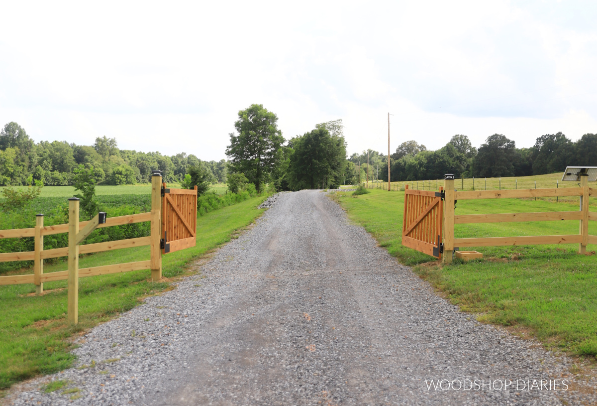 DIY wooden driveway gates opened on gravel driveway