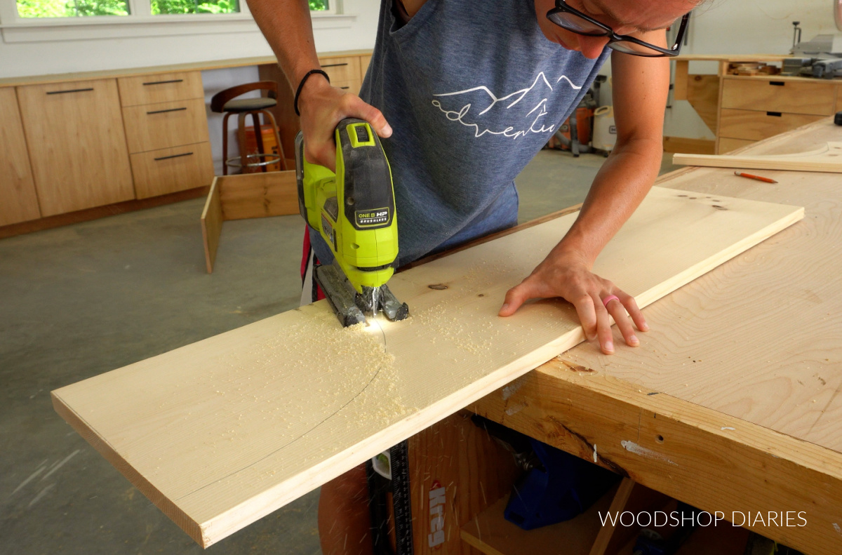 Shara Woodshop Diaries cutting arch out of hutch divider boards with jig saw