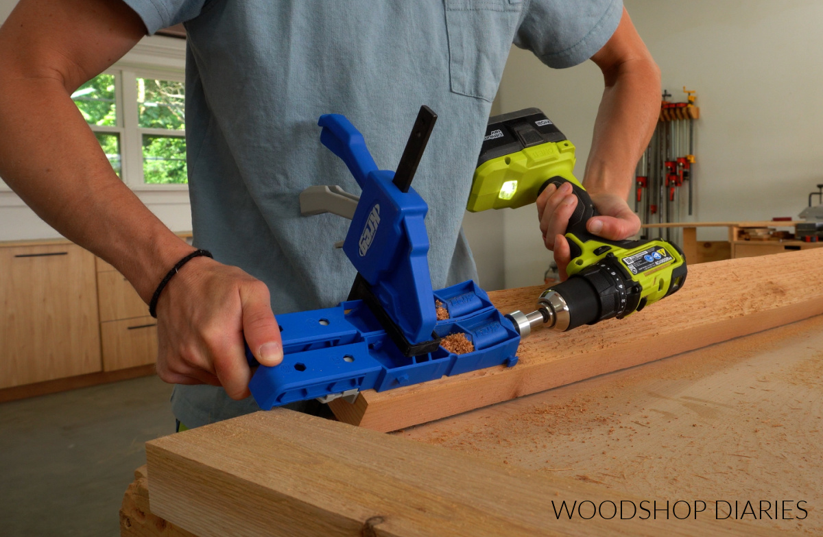 Shara Woodshop Diaries drilling pocket holes into the ends of 2x4 cedar board on workbench
