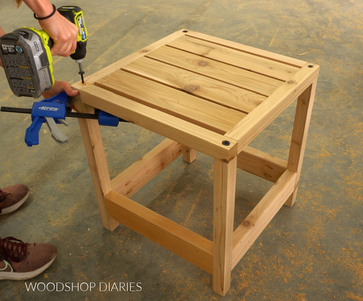 Securing umbrella stand top to table base at corners with timber screws