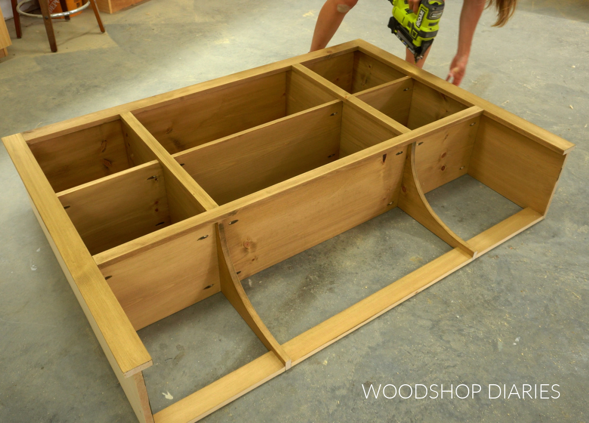 Shara Woodshop Diaries brad nailing face frame onto front of hutch