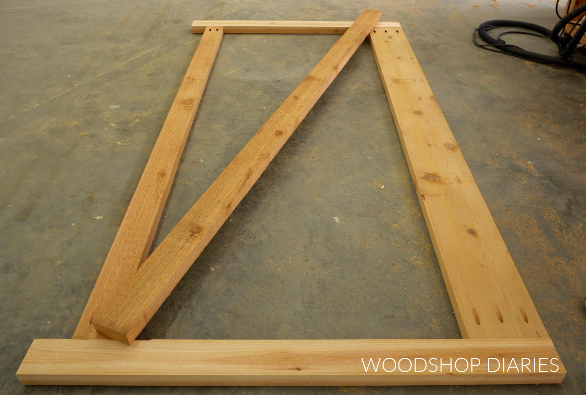 2x4 diagonal board laying across gate frame