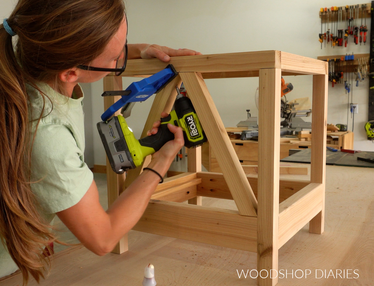 Shara Woodshop Diaries securing side table braces with screws in workshop
