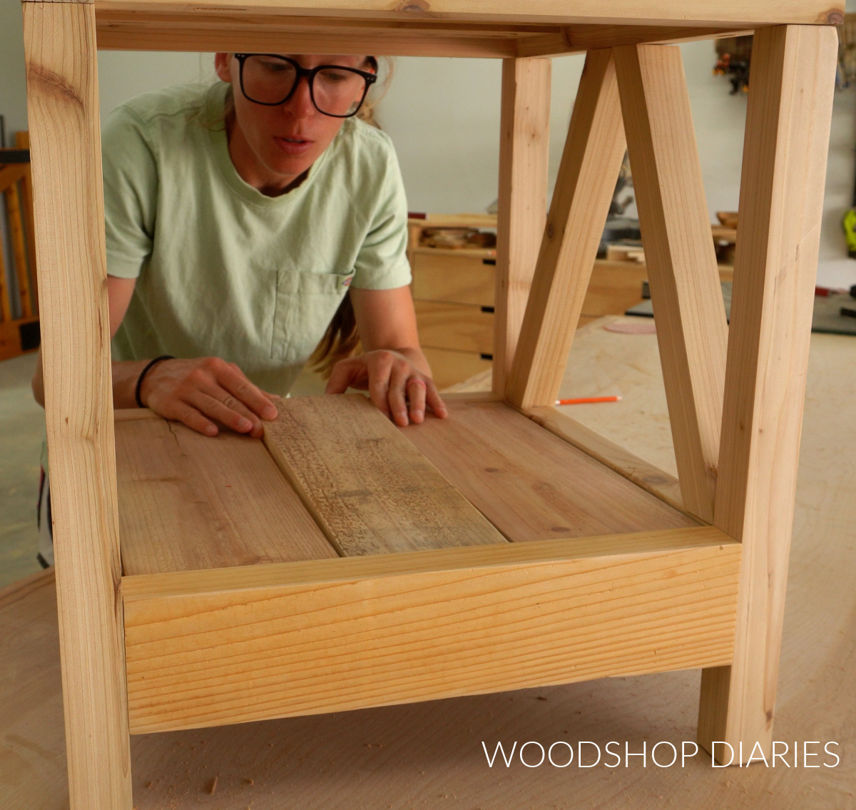 Shara Woodshop Diaries placing bottom slats on supports of umbrella stand table