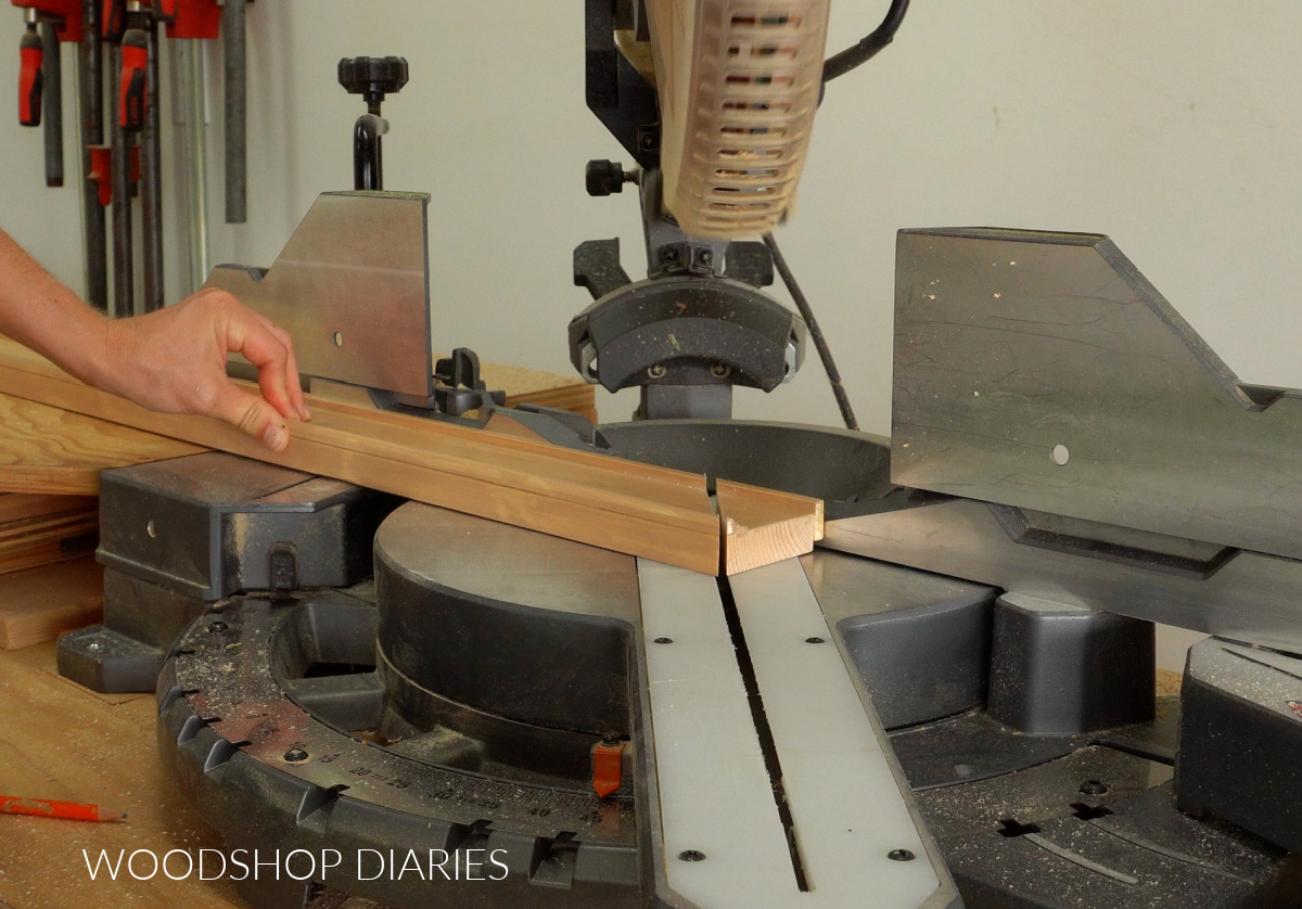 Miter saw set to 45 degrees cut end off picture frame board
