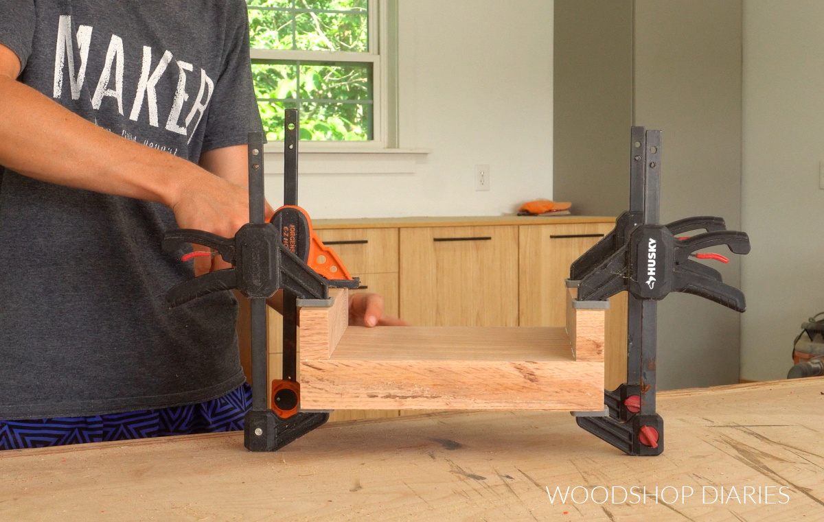 Shara Woodshop Diaries gluing runners on bottom of red oak board to make DIY wooden riser