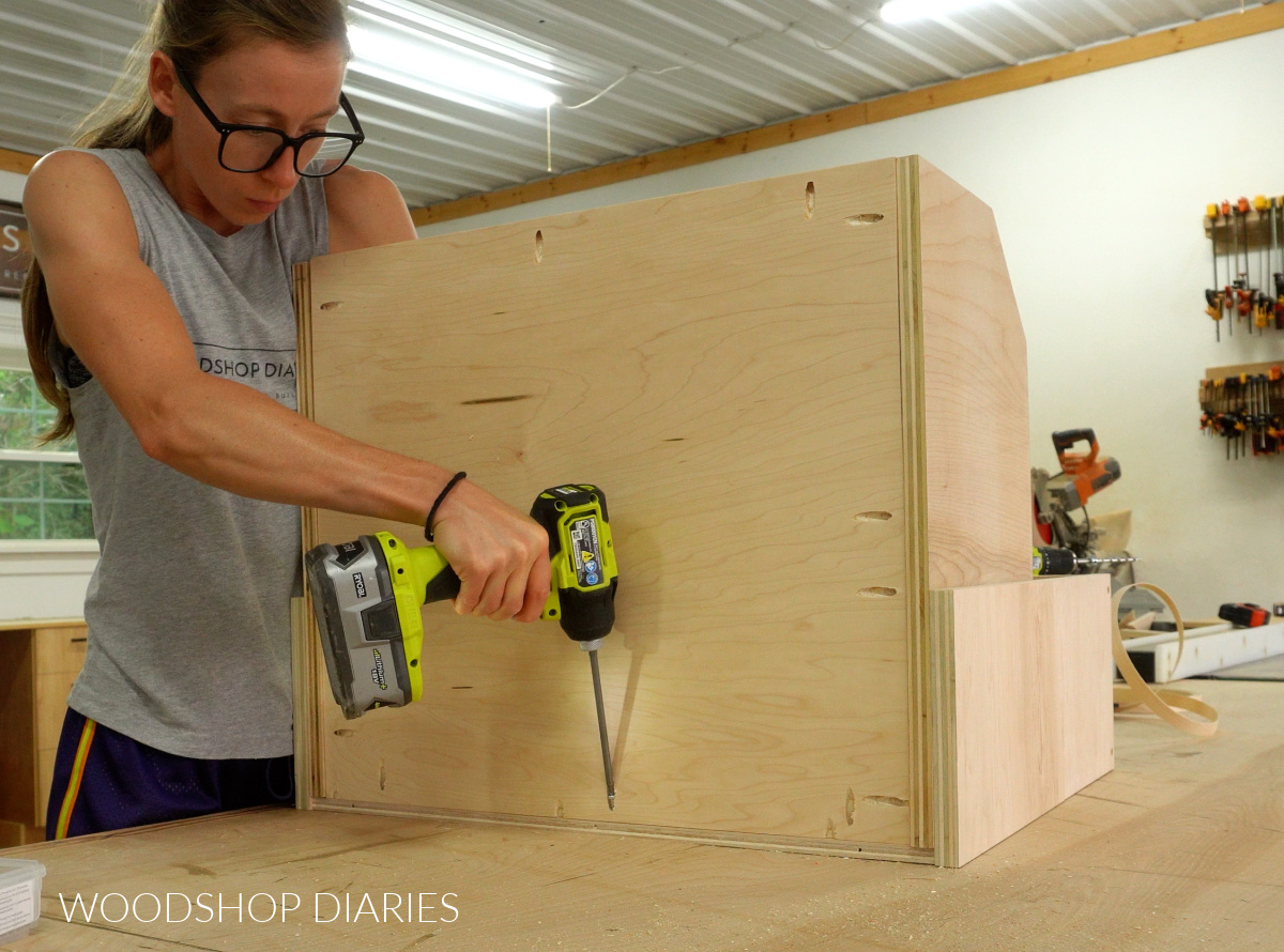 Shara Woodshop Diaries installing back panel into pots and pans organizer with pocket hole screws