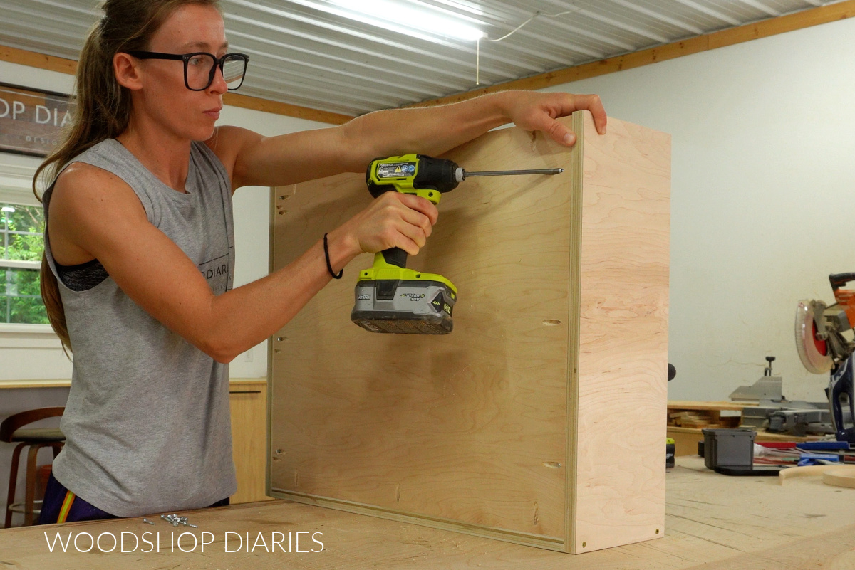 Shara Woodshop Diaries installing bottom panel of pots and pans pull out tray with pocket hole screws