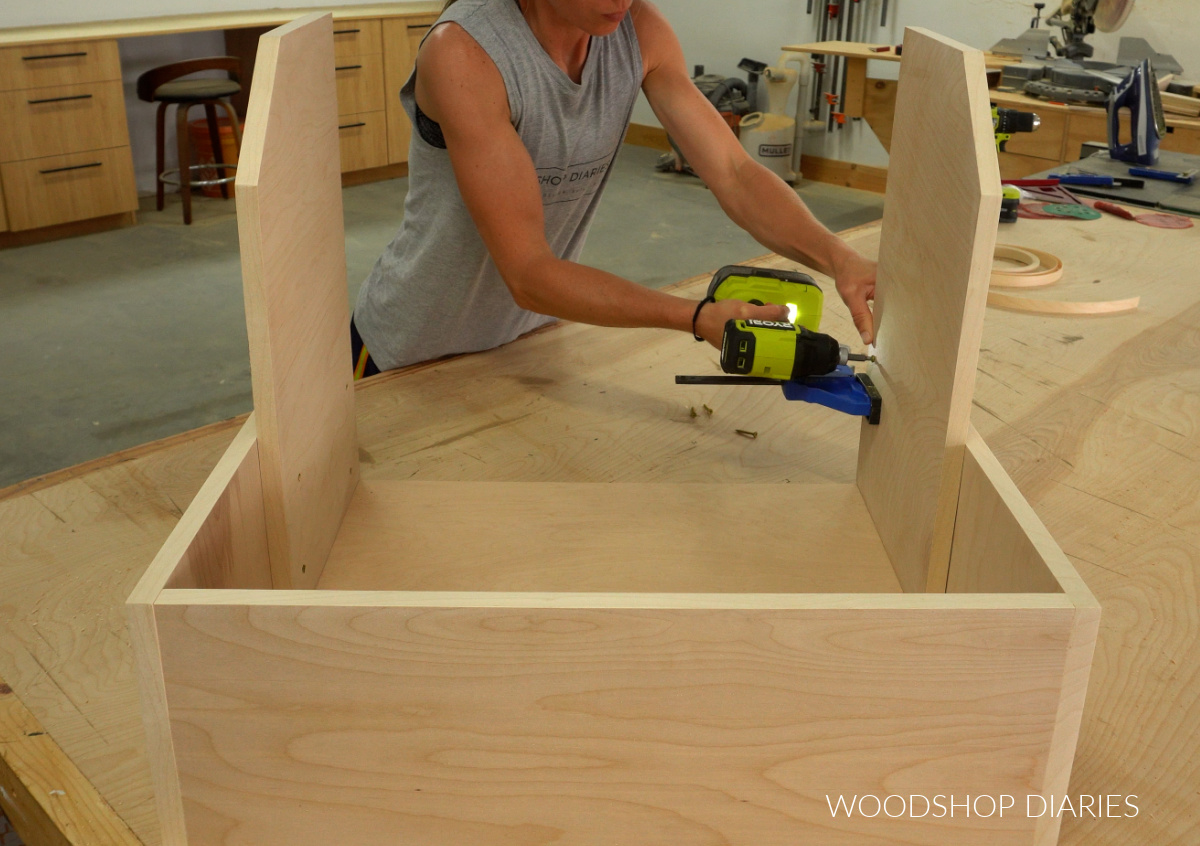 Shara Woodshop Diaries screwing side panels into pots and pans cabinet organizer