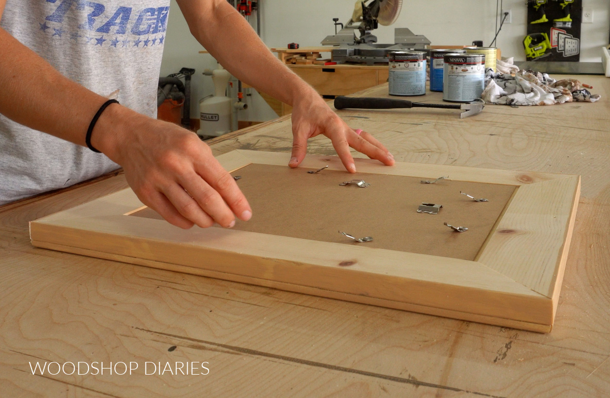 Test fitting backer board into frame on workbench