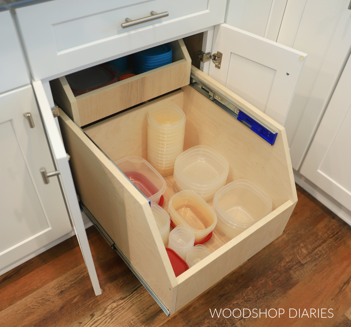 Plywood DIY cabinet organizer drawer in base kitchen cabinet pulled out on slides with top drawer pushed back into cabinet