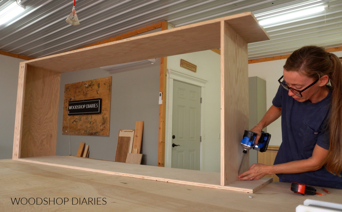 Shara Woodshop Diaries assembling coat armoire cabinet with pocket hole screws on workbench