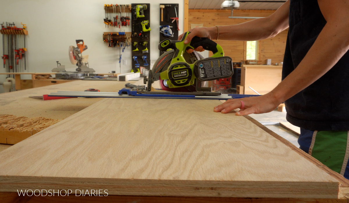 Shara Woodshop Diaries cutting plywood with circular saw on workbench