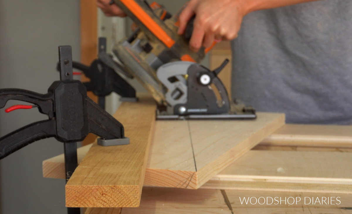 Shara Woodshop Diaries running circular saw along straight edge to cut down diagonal of 1x8 board