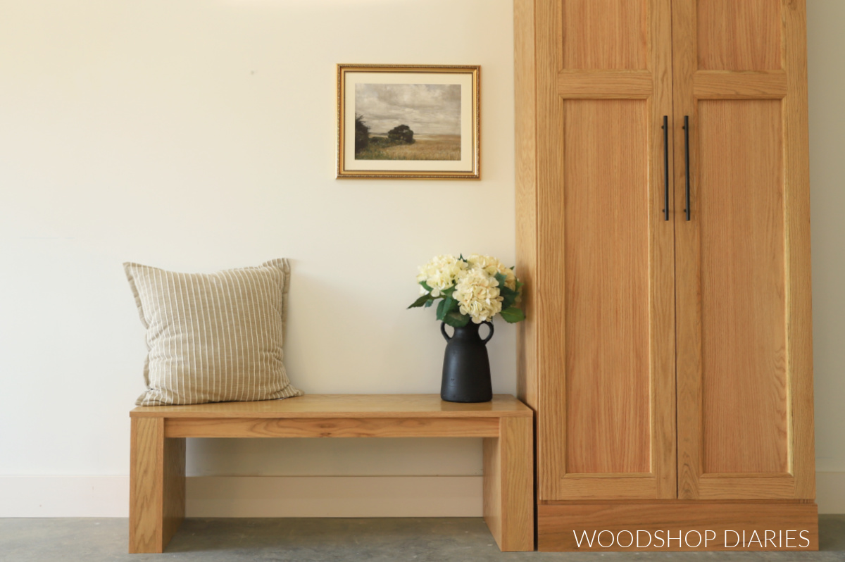 Modern DIY Red oak bench sitting next to red oak cabinet against white wall