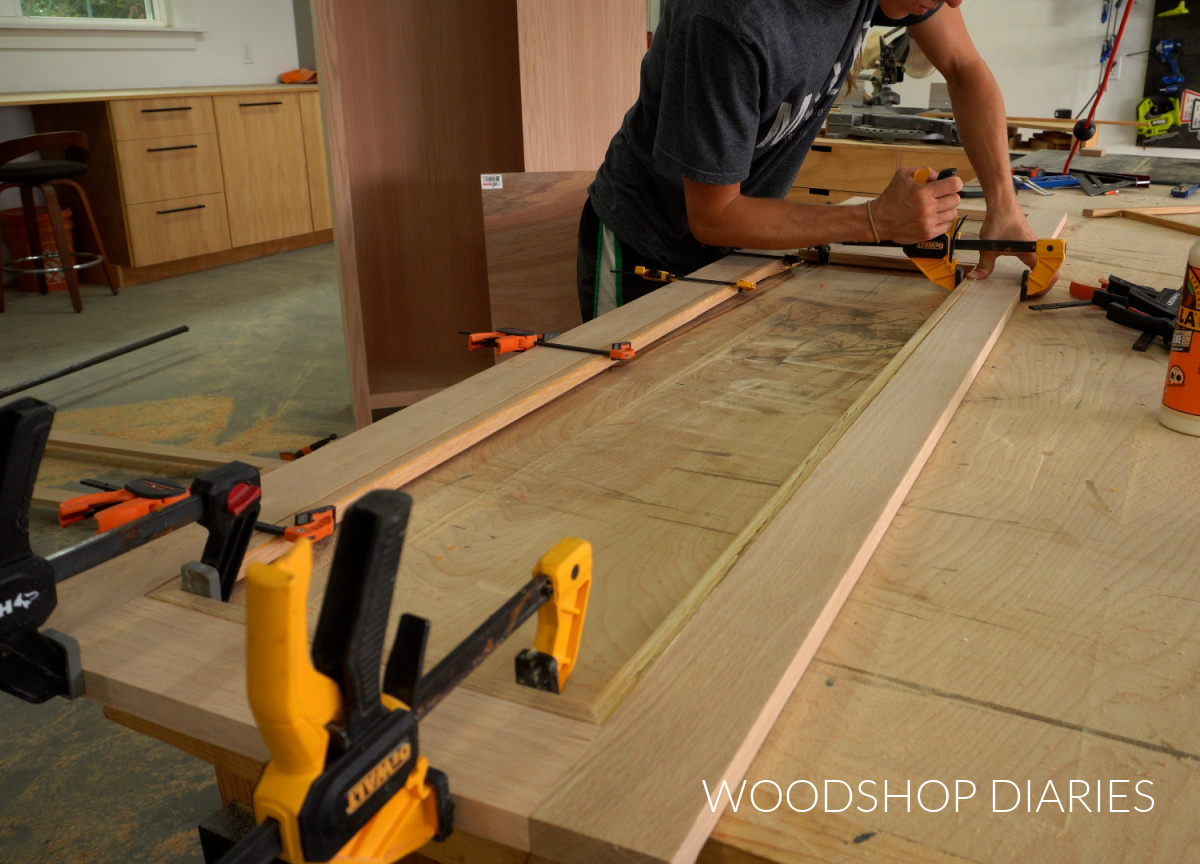 Shara Woodshop Diaries clamping small trim pieces to line door openings for coat storage cabinet