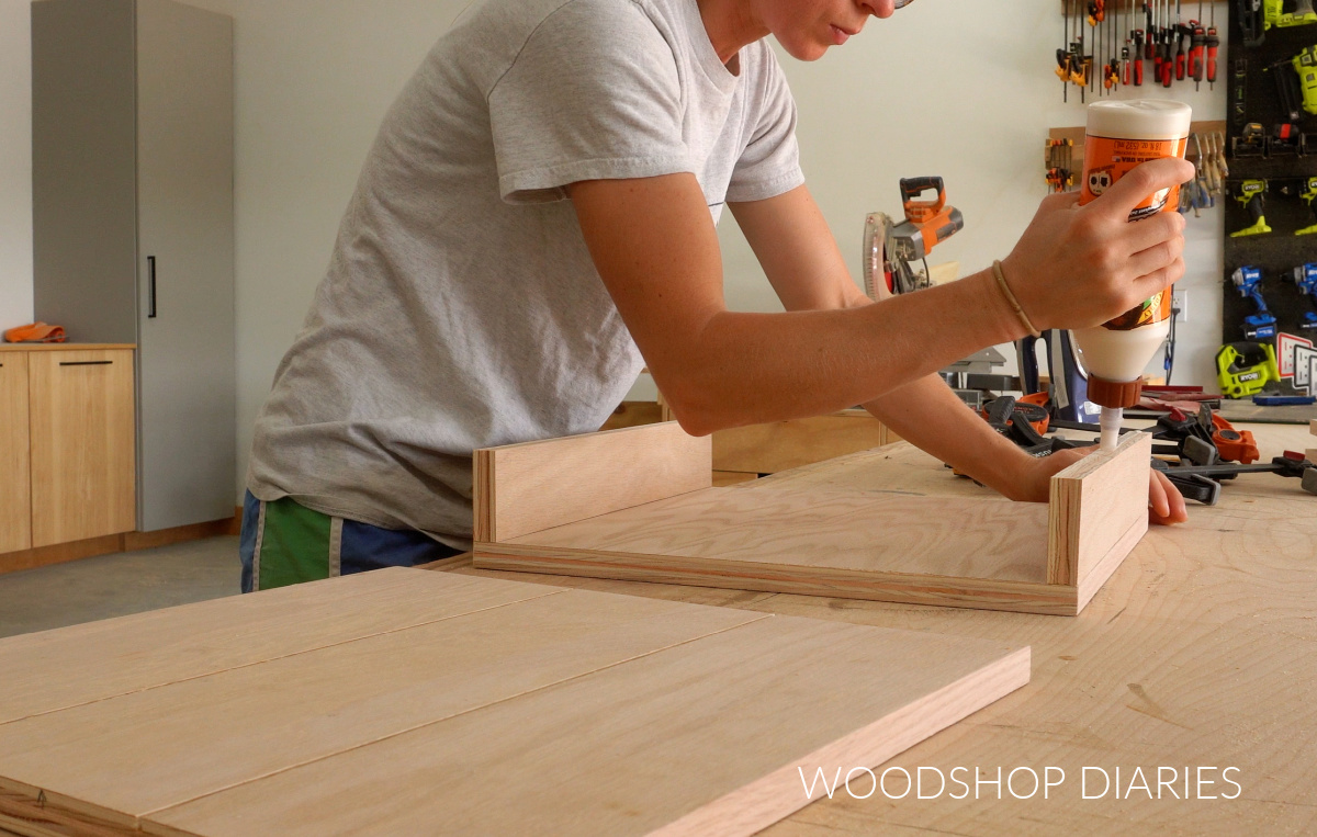 Shara Woodshop Diaries applying wood glue to make chunky boxes for DIY bench legs