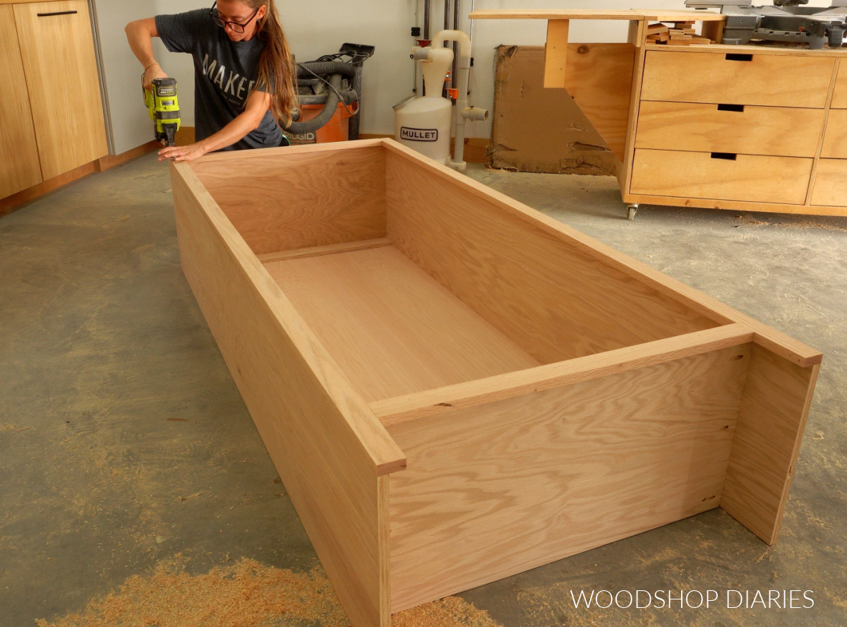 Shara Woodshop Diaries using brad nailer to secure face frame to coat cabinet box