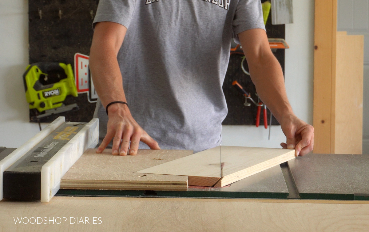 Shara Woodshop Diaries running twisty table jig and board through table saw to cut legs