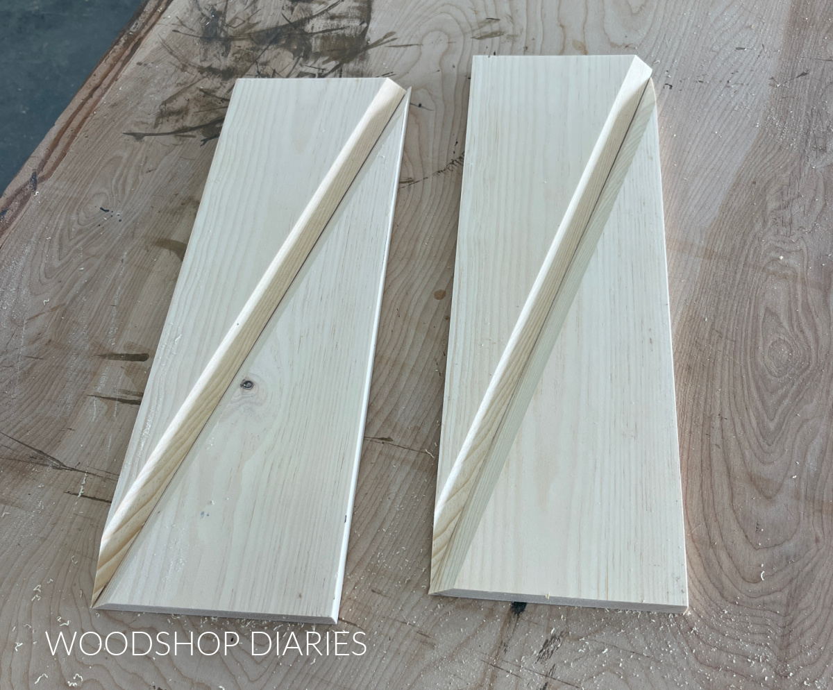 two twisty table legs cut on workbench showing v notched out along diagonals of each