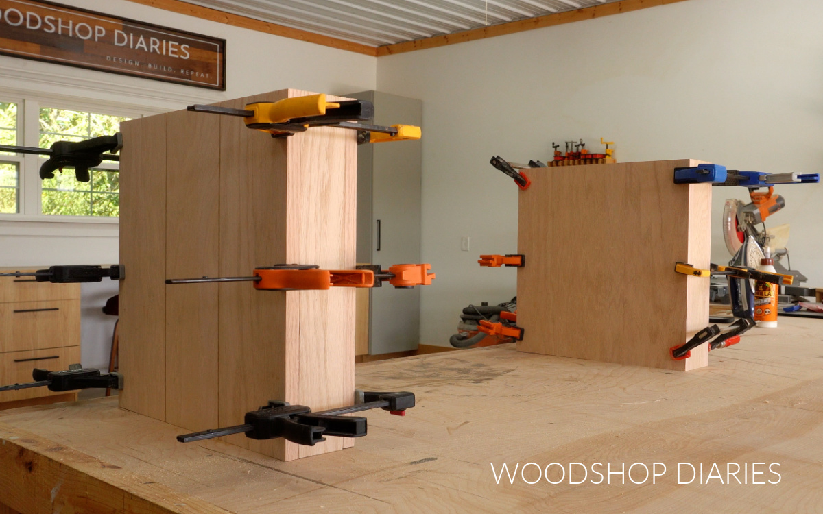 Two hollow plywood boxes glued and clamped on workbench