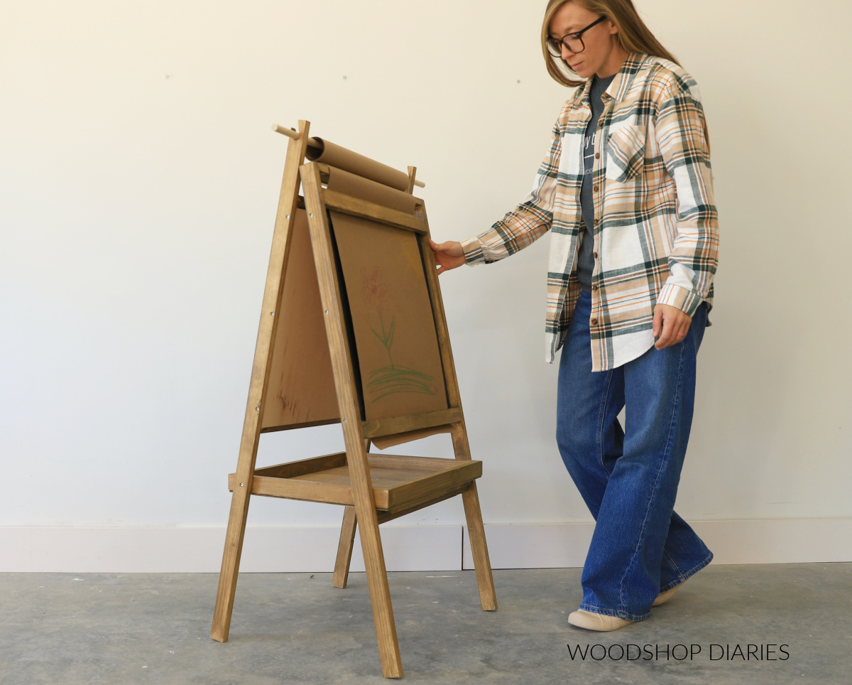 Shara Woodshop Diaries standing next to open art easel with tray in locked position