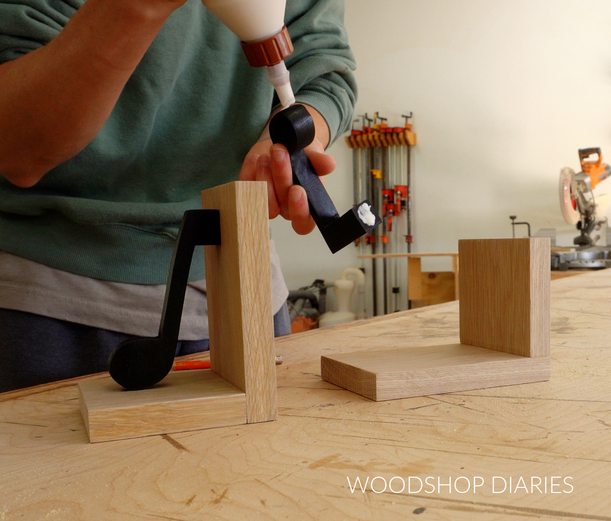 Shara Woodshop Diaries applying wood glue to music notes to attach them to bookends