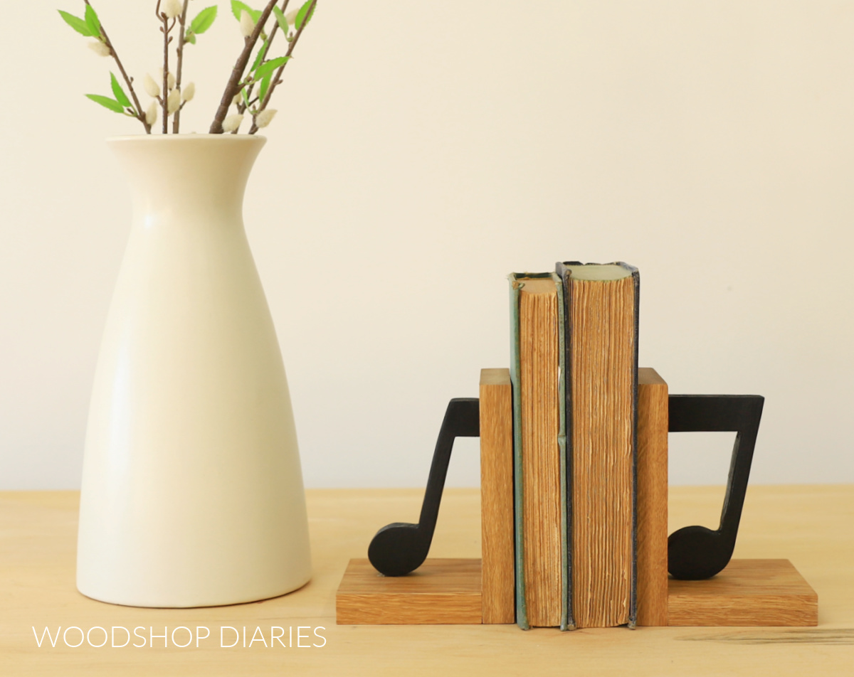 Wooden bookends with music notes on both sides of two old books