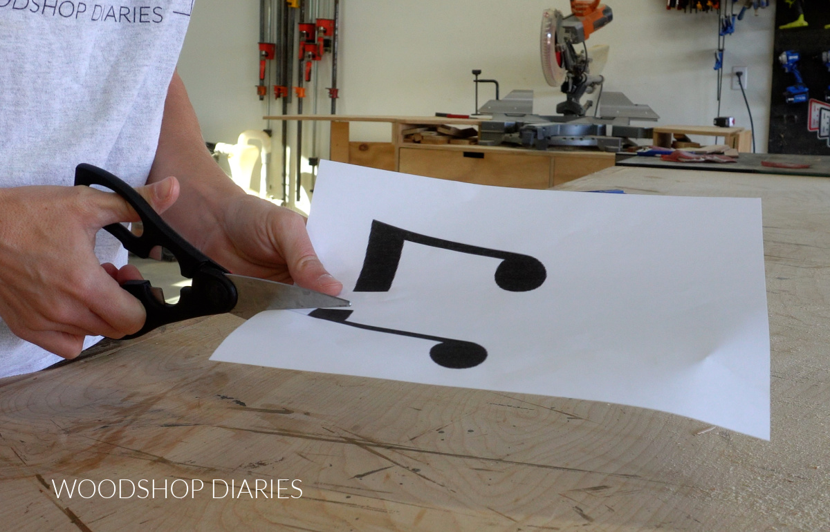 Shara Woodshop Diaries cutting out music note shape from a piece of paper with scissors
