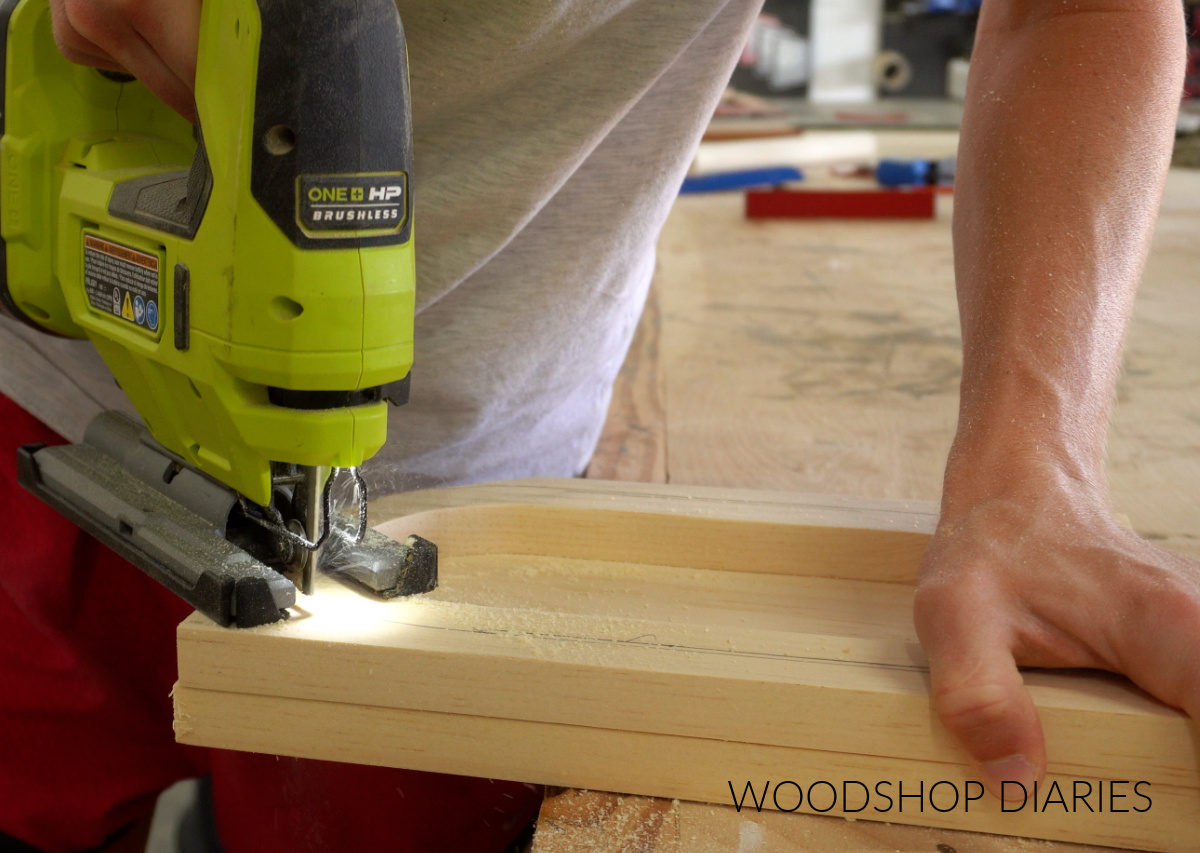 Close up of Shara Woodshop Diaries cutting catch all tray to final shape with jig saw