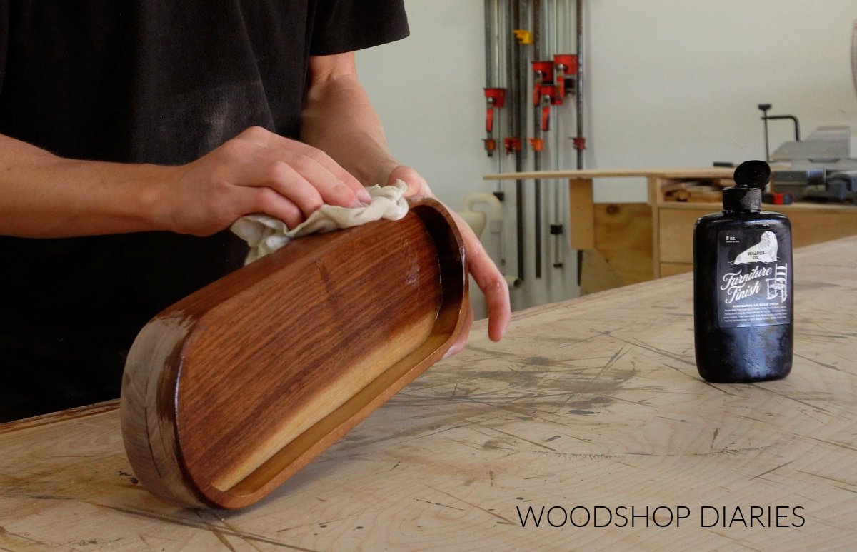 Shara Woodshop Diaries applying furniture finish to walnut catch all tray on workbench
