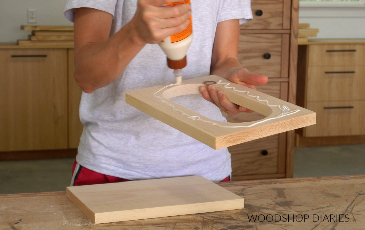 Shara Woodshop Diaries applying wood glue to bottom of oval cut out shape board