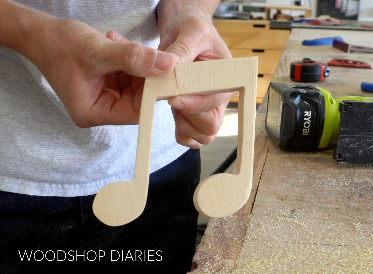 Music note pieces cut out and held together to show overall shape