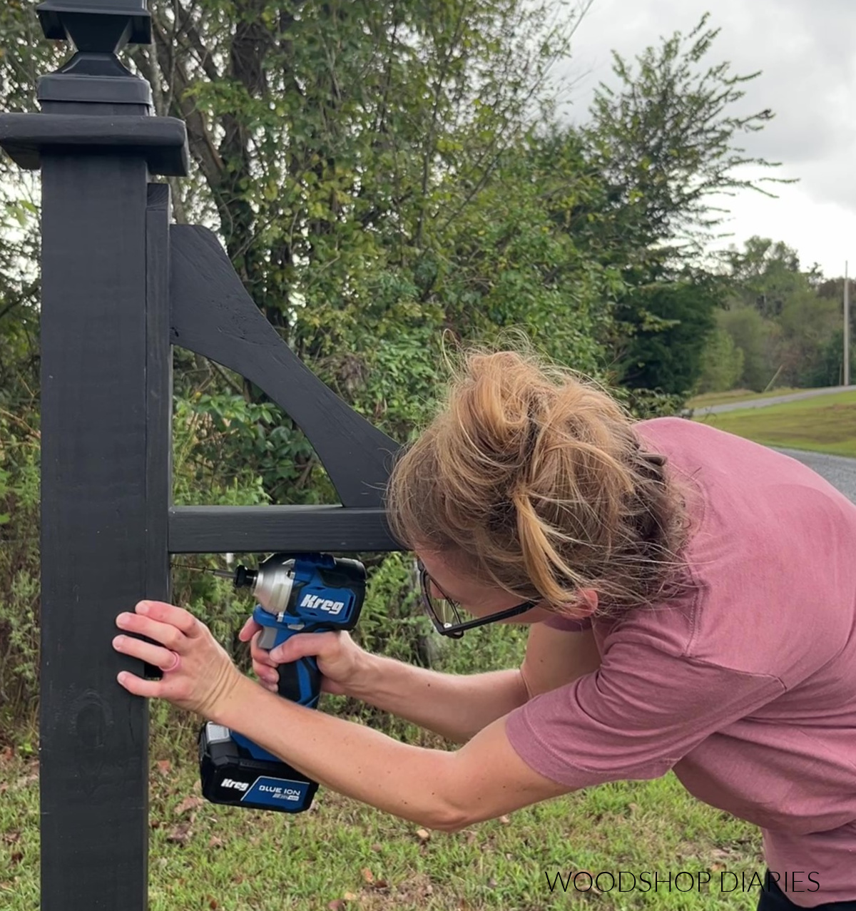 Shara Woodshop Diaries installing sign hanger onto DIY lamp post