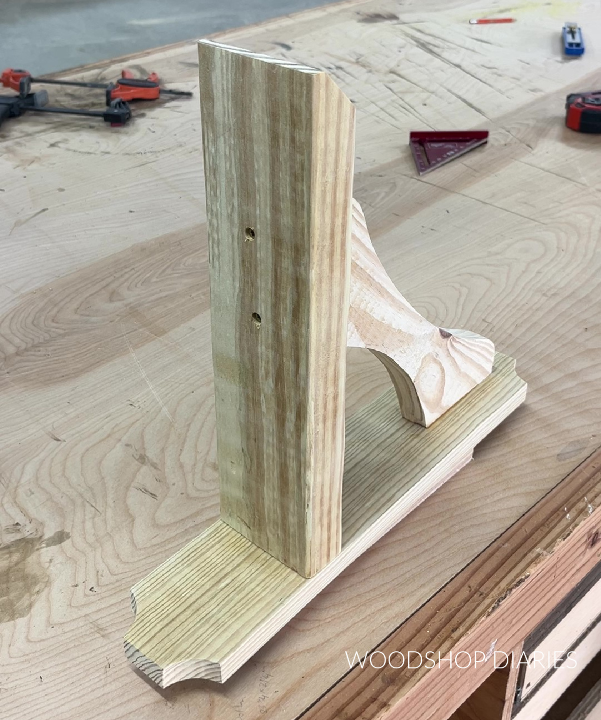 sign hanger for DIY lamp post assembled on workbench from treated scrap boards