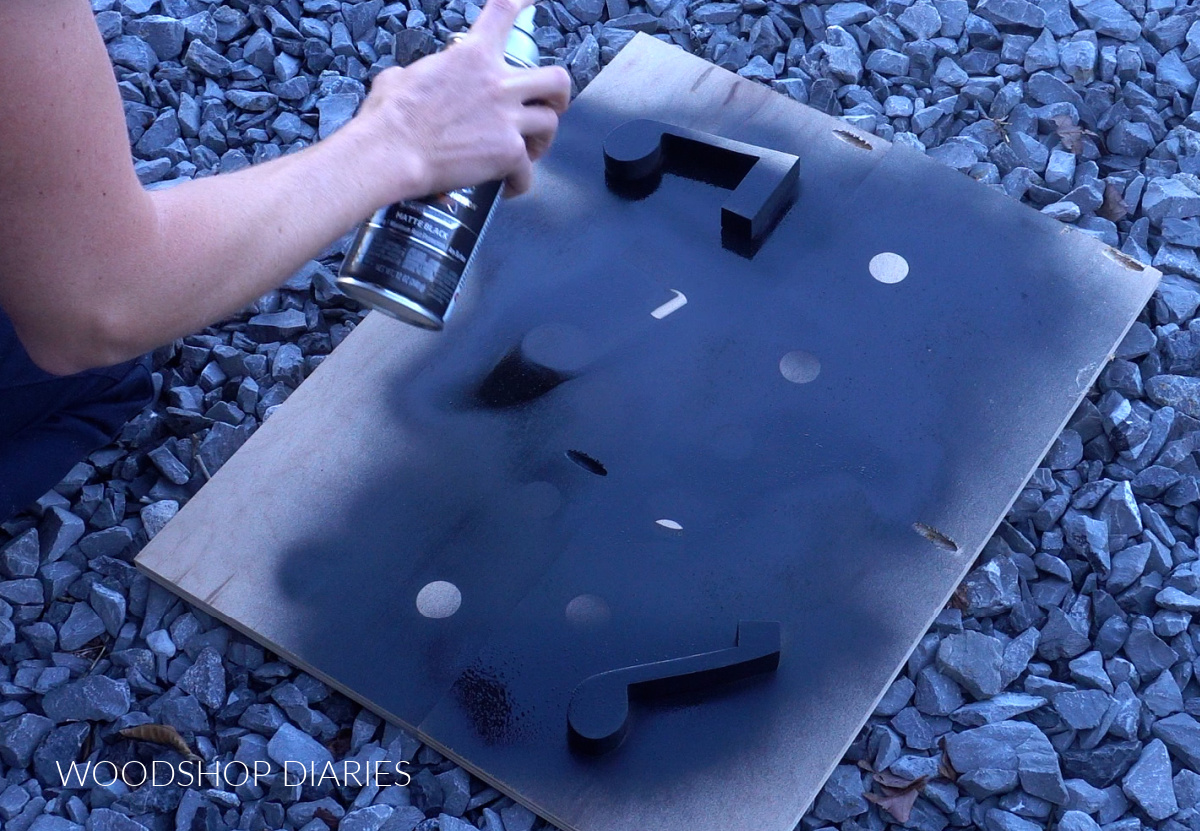 Shara Woodshop Diaries spray painting music note pieces for DIY wooden bookends