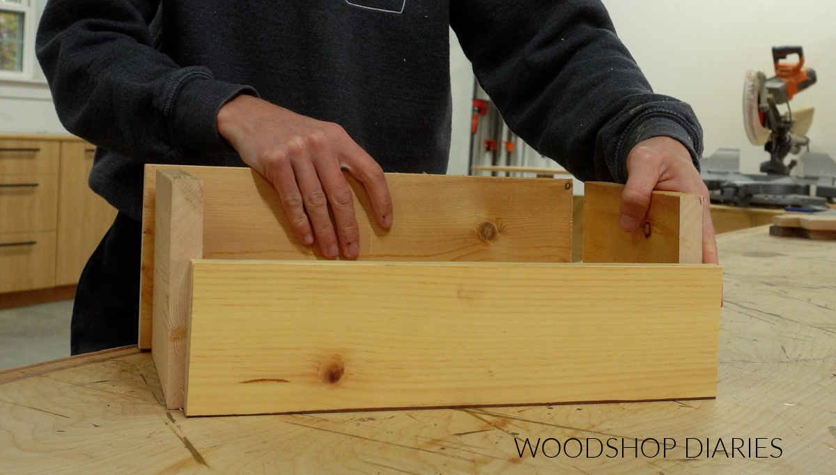 Shara Woodshop Diaries dry fitting wood pieces of dinnerware caddy together on workbench