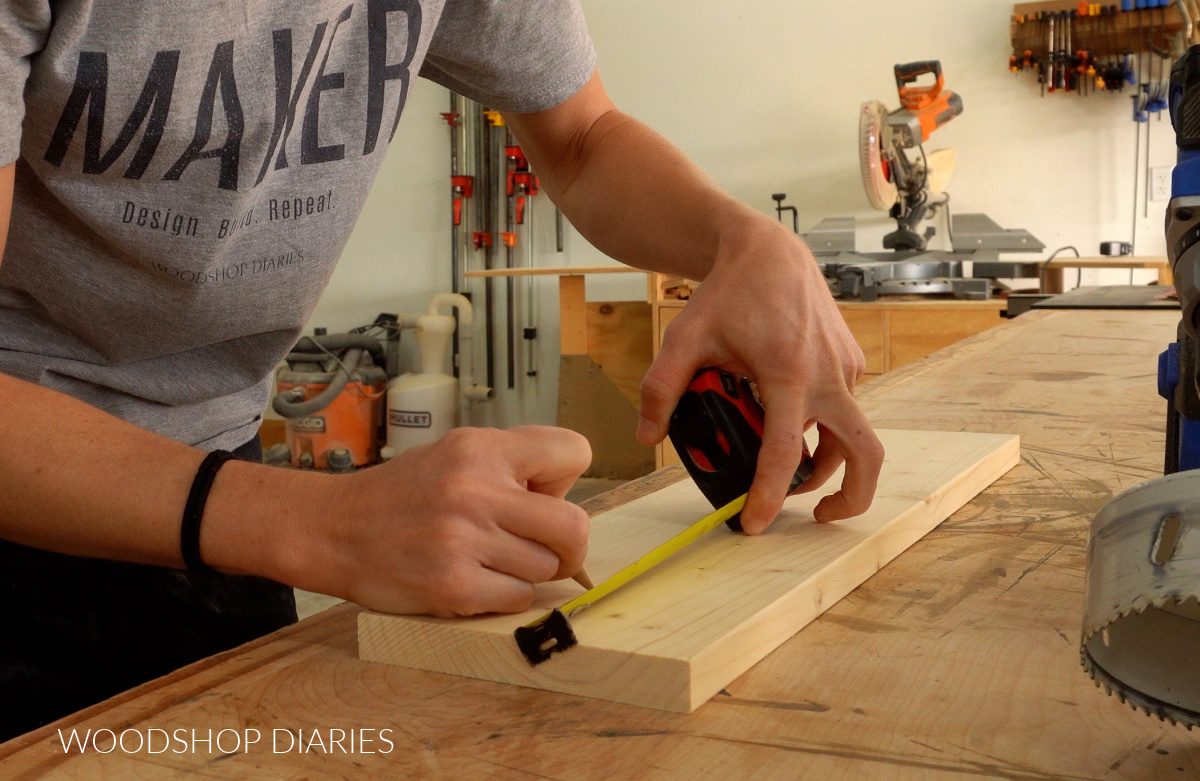 Shara Woodshop Diaries marking hole location on scrap 1x6 board