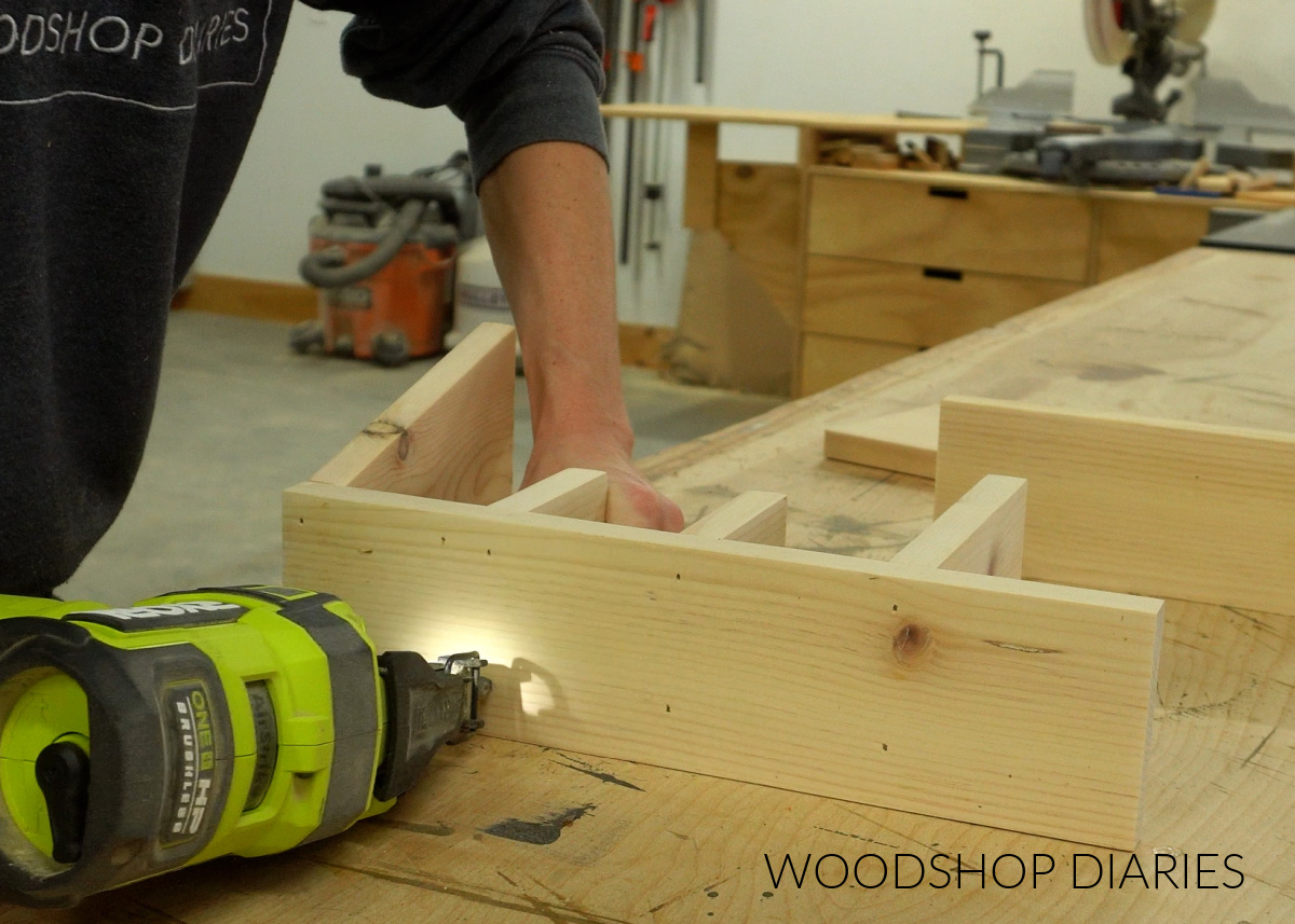 Shara Woodshop Diaries brad nailing cutlery dividers onto dinnerware caddy