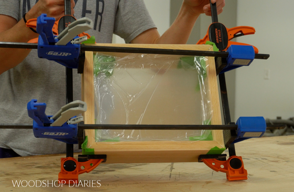 Shadow box in clamps on workbench