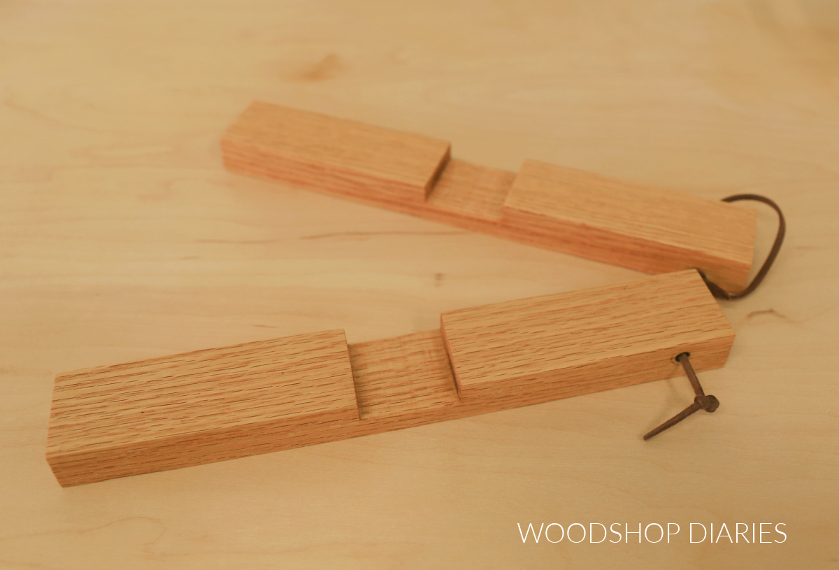 DIY wooden cross trivet unlocked laying on tabletop