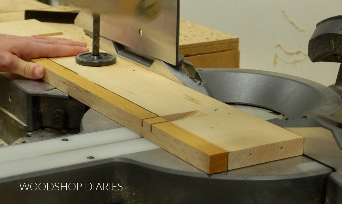 Close up showing end cut marks on trivet board in miter saw