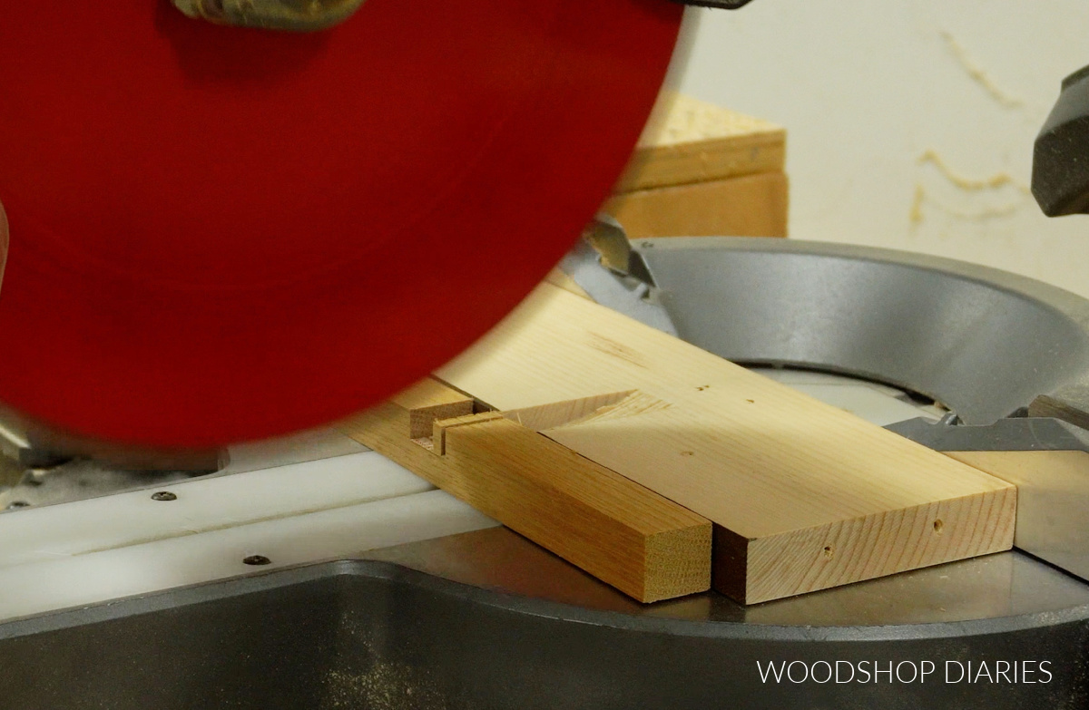 Close up of miter saw cutting notch in square dowel to make wooden trivet