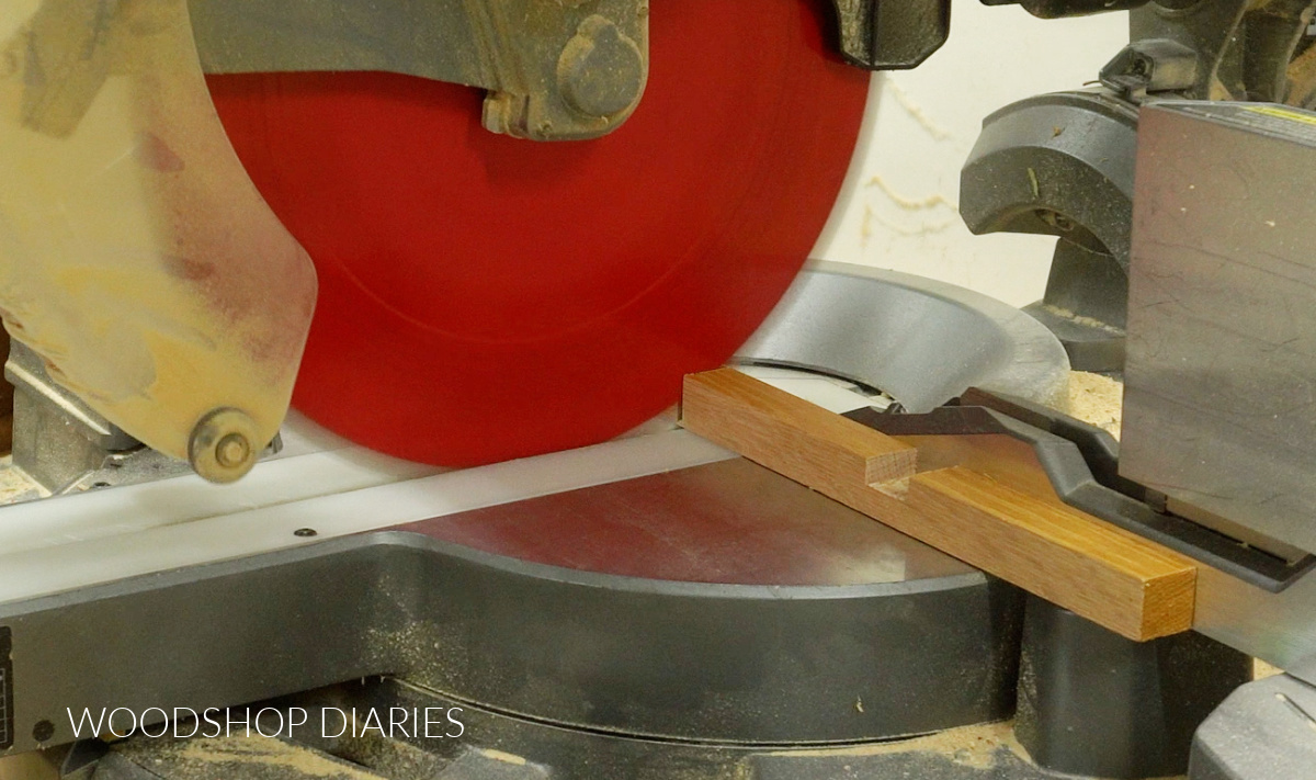 Close up of miter saw cutting square dowel